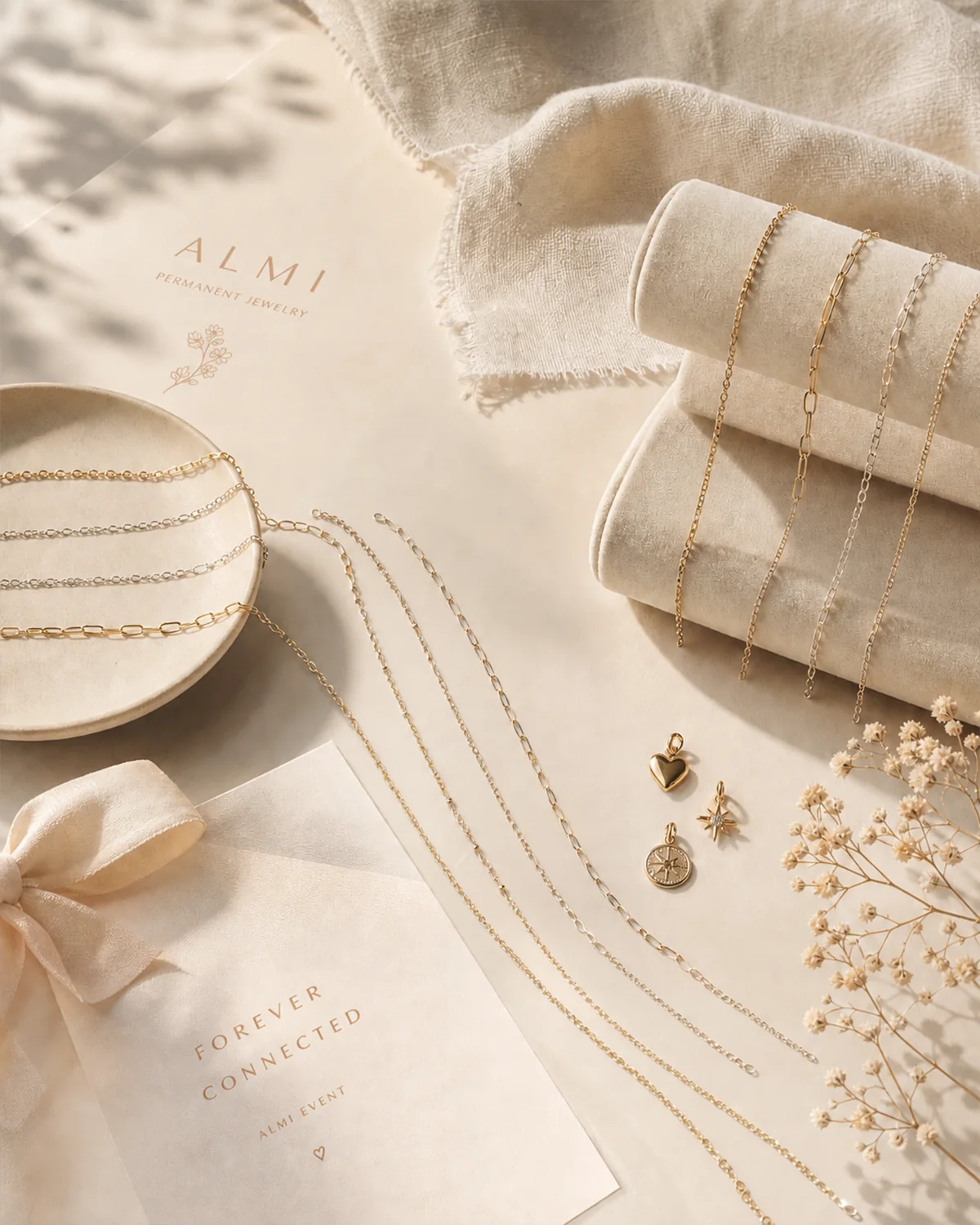 ALMI jewelry and stationery arranged in the brand’s warm ivory and gold visual system