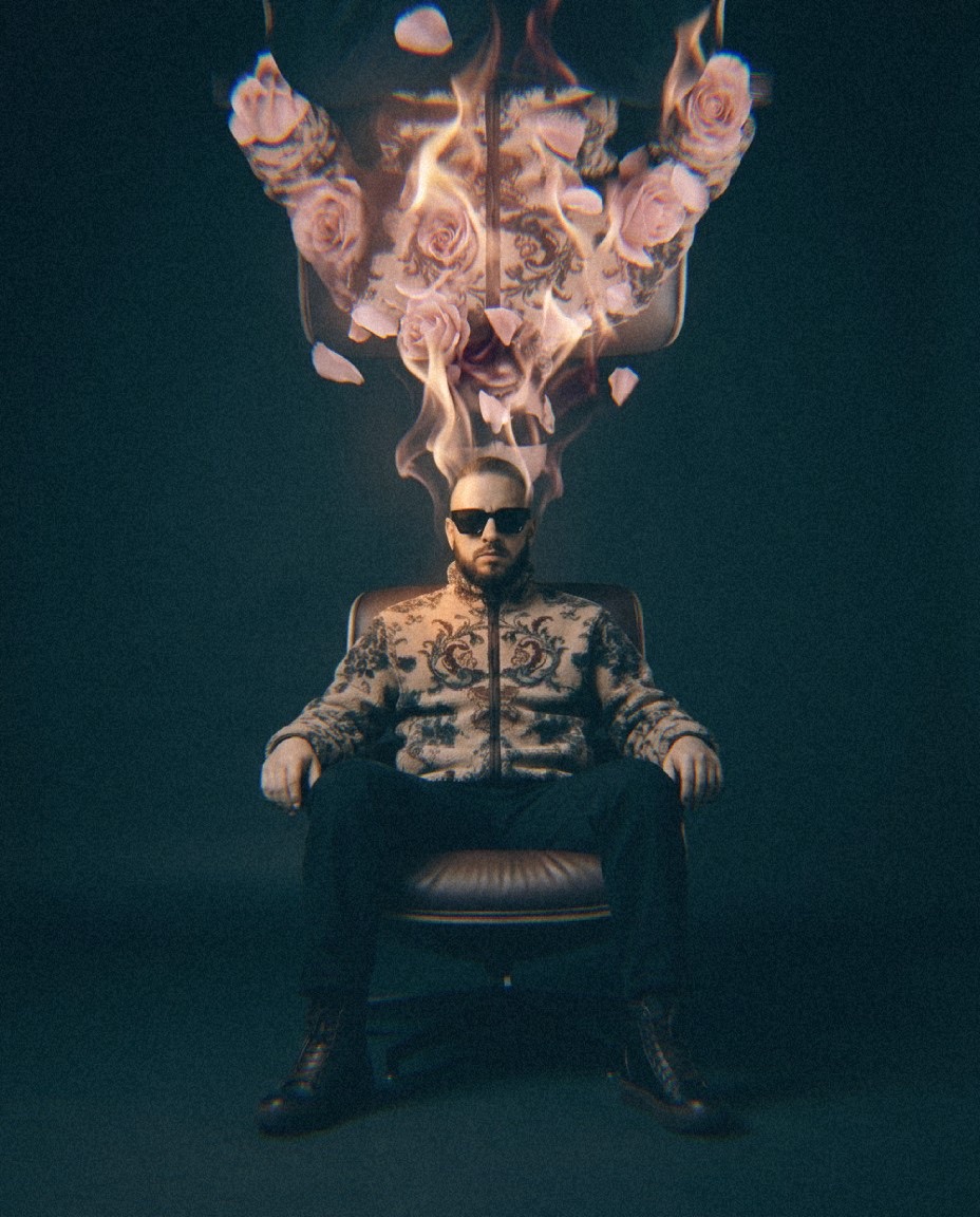 Henrix, founder and creative director of HNRX Studio, seated beneath a burning arrangement of roses