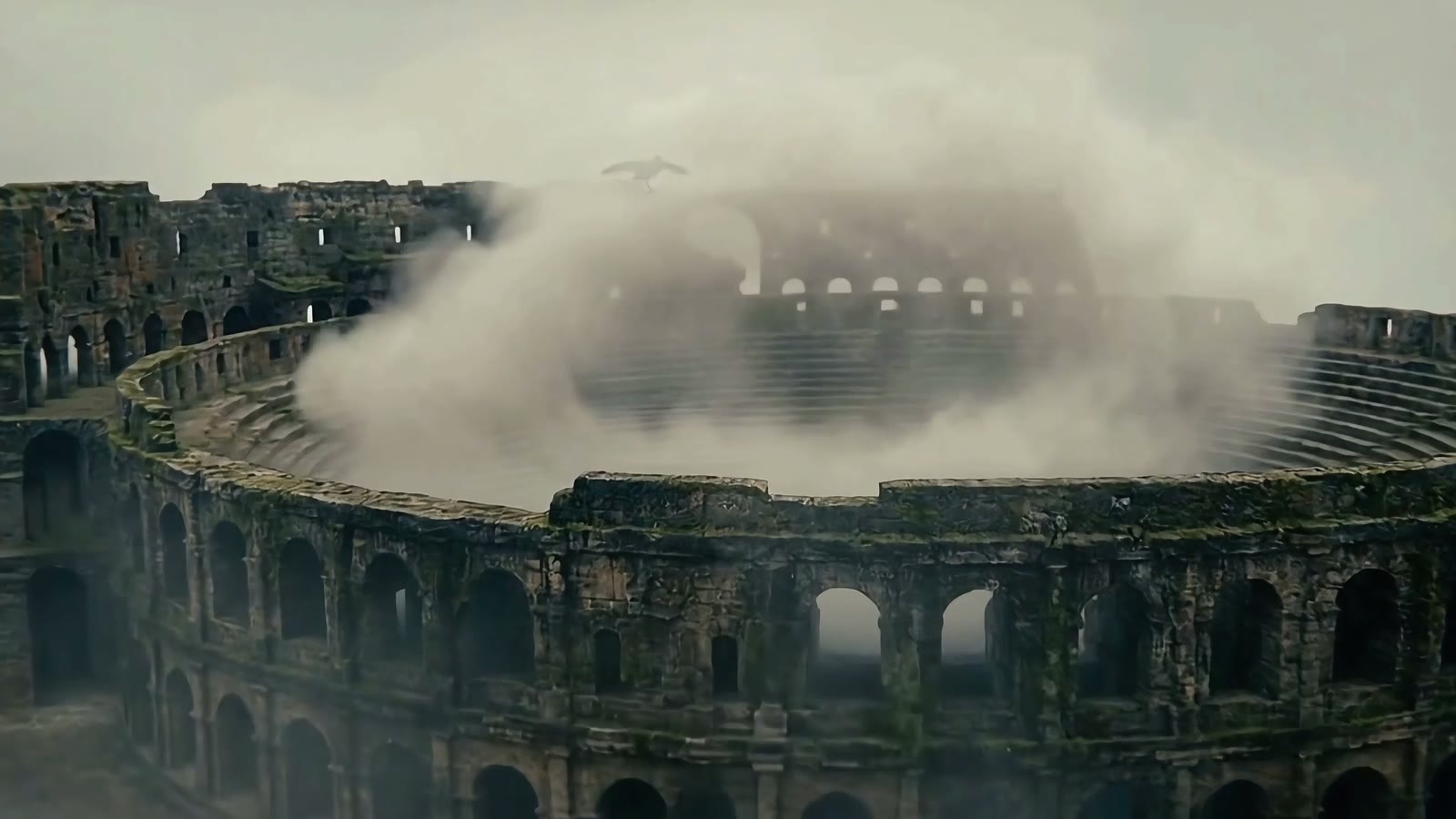 A vast ruined arena filled with fog