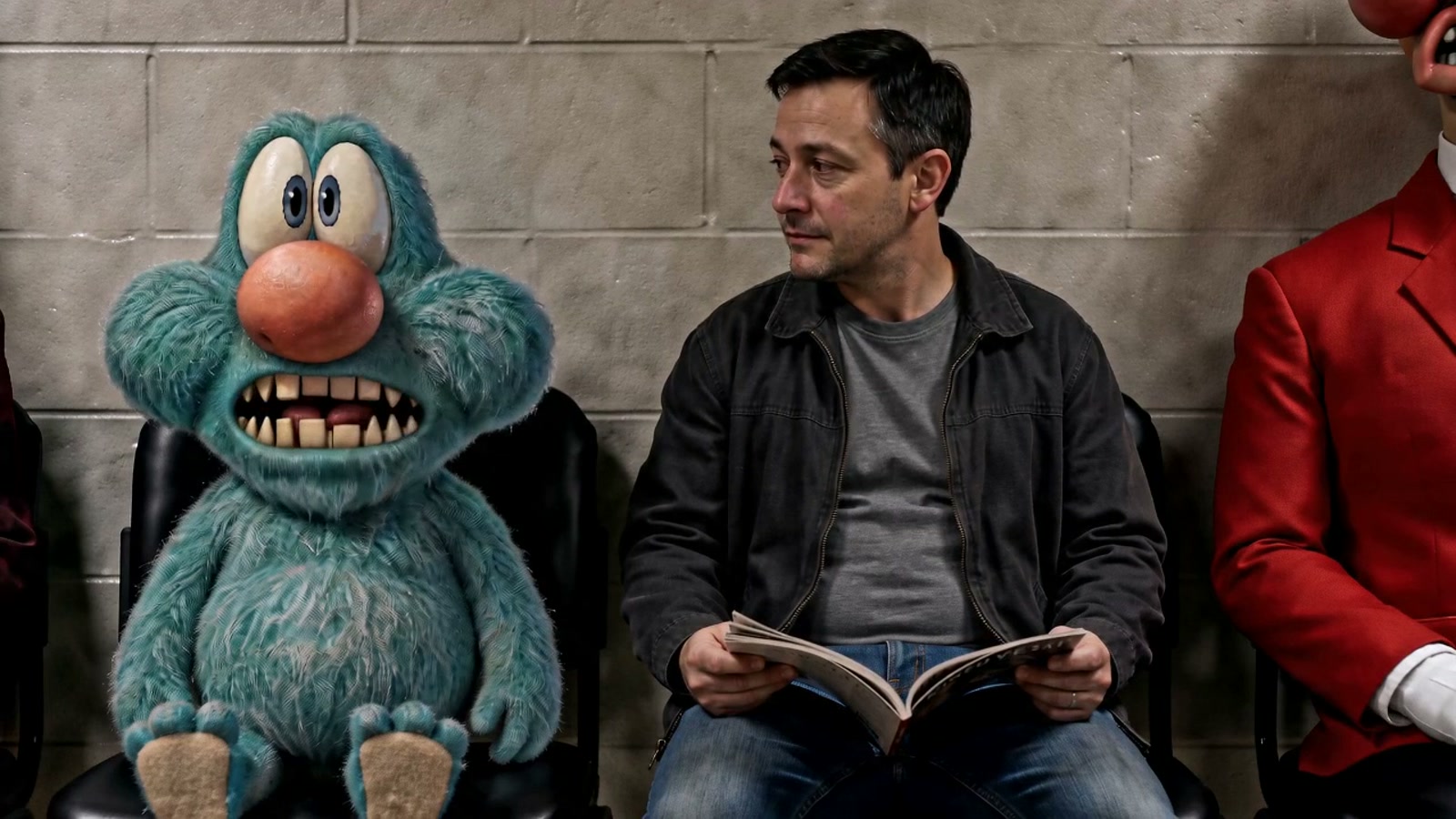 The man sits beside Tiny and opens a magazine