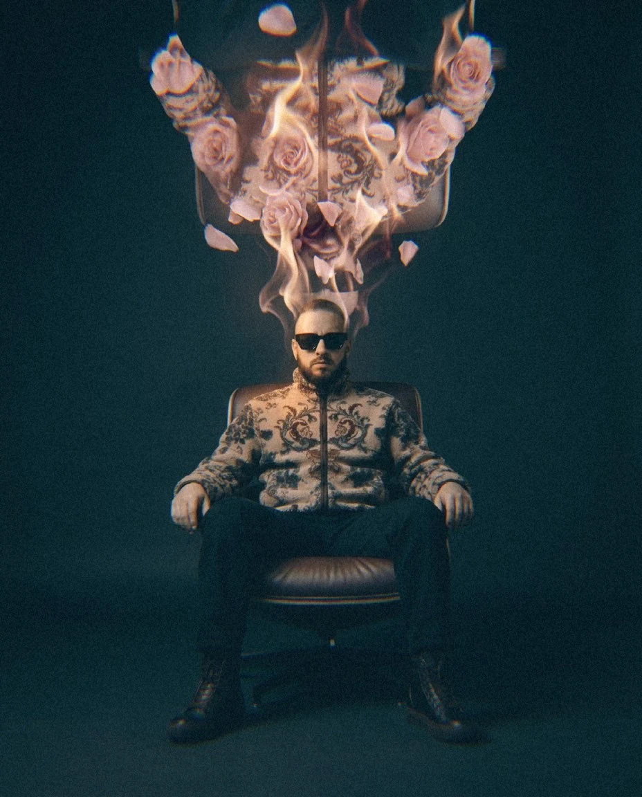Pedro Henriques, founder and creative director of HNRX Studio, seated beneath a burning arrangement of roses