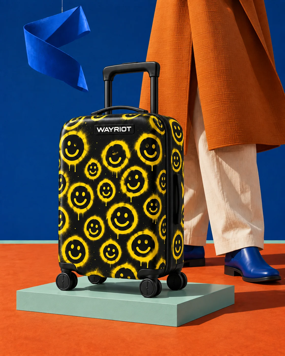 Black and yellow Spray Smiles case against orange tailoring and mint plinth
